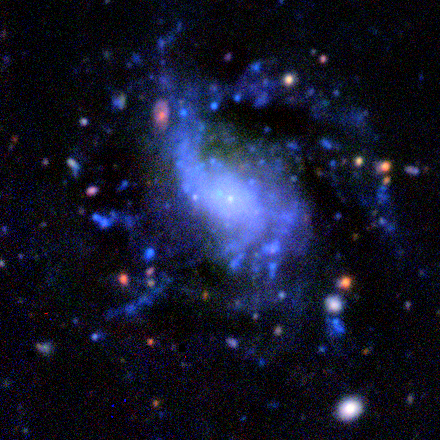 very small nucleus, can see a distant red galaxy through the disk.